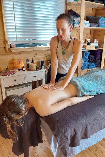 Massage therapist treating client
